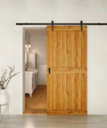 Wooden barn door with black hardware installed in a modern interior setting, showcasing use for Recessed Finger Flush Pulls 6 Inch Aluminum Rust Proof.
