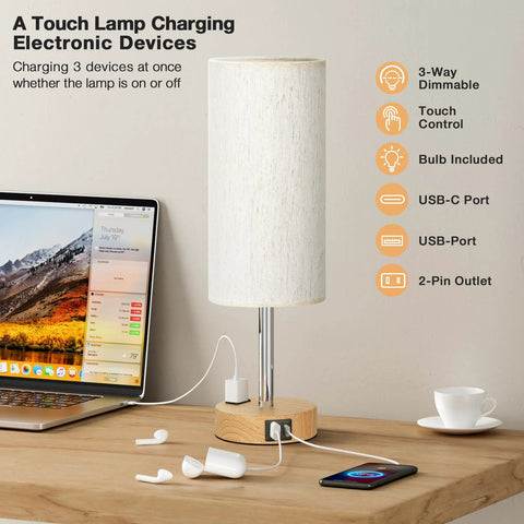 Bedside Table Lamp With 3 Way Dimmable Touch Control, USB C Charging Ports And AC Outlet on wooden desk with devices charging