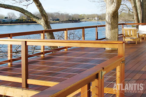 Wooden deck with Long Stud 1/8 Inch For HandiSwage Cable Infill Systems Pack Of 2, overlooking a body of water, trees in background.