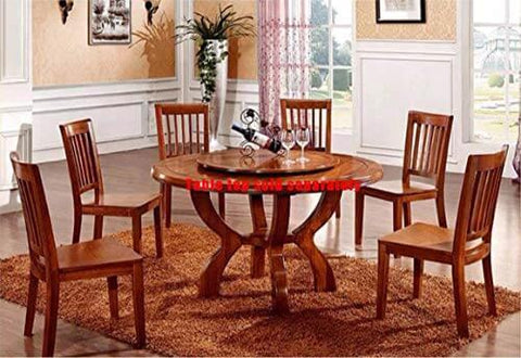 Wooden dining table set with round tabletop and six matching chairs, wine and glasses displayed, in a warmly lit dining room setting.