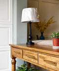 Wooden desk with two pack antique brass cabinet pulls, lamp, and plant