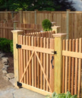 Outdoor wooden fence with installed Beefy Wood Gate Hardware Kit With 3-1/2 Inch T Hinges, heavy duty latch, decorative handle, black finish.