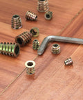 230 Piece Threaded Wood Inserts Set With 11 Sizes M4 M5 M6 M8 M10 Hex Socket Drive Furniture Fasteners on wooden surface