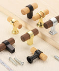 Assorted beech wood and metal T-bar drawer pulls on beige fabric, highlighting various finishes and styles. Includes screws and ruler for scale.