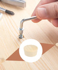 Close-up of hand using Allen key on wood board with 50 Pack Five Eighth Inch Flat Head Wood Plugs That Cover Screw Holes For Furniture Cabinets And DIY Projects Assortment Kit Includes Wood Plug Caps For Seamless Finish And Concealment In Tables Legs And Outdoor Gear.