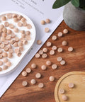 Flat Head Wood Plugs Set, 100 Pcs Three Eighths Inch Screw Hole Plugs scattered on wood surface and tray