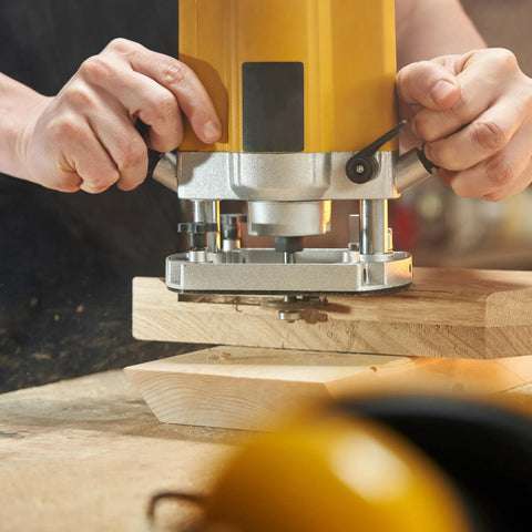 Craftsman using Five Sixteenth Inch Internal Threaded Clamping Knobs for T Track Jigs and Fixtures in routing setup