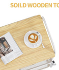 Top view of a 3-Tier Metal Rolling Cart With Wood Top And Drawer, White On Wheels, with a magazine and coffee cup on the wood top.