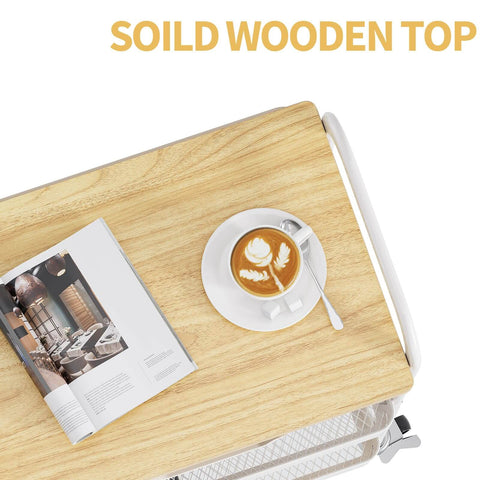 Top view of a 3-Tier Metal Rolling Cart With Wood Top And Drawer, White On Wheels, with a magazine and coffee cup on the wood top.
