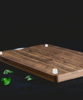 Wood surface with installed 12 Pack Rubber Bumper Feet 0.35 In High By 0.55 In Wide Round Pads, preventing damage and slippage.