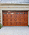 Wooden garage door with 8 Inch Hammered Cast Iron Door Handle Heavy Duty Barn Door Pull in rustic black, installed on stone garage, includes screws.