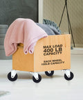 Wooden crate on 4 Pack Swivel Stem Casters With 2 Inch Rubber Wheels, Three Eighths Inch Threaded Stem, holding blankets.