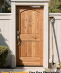 Wooden single door with intricate carvings and a metal lock in a white frame, shovel leaning against door, outdoor setting with greenery