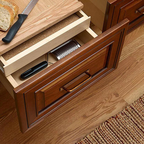 Top-down view of an open kitchen drawer with wooden cabinet adorned with a Set Of 12 Antique Brass Cabinet Pulls With Back Plates, 5-inch length.