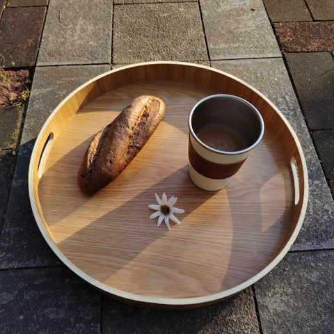 16 Inch Lazy Susan Turntable With Handles Wooden Rotating Tray With Raised Rim holding bread and cup on stone surface