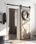 6.6 FT Sliding Barn Door Soft Close Hardware Kit installed on a wooden door with wreath, showcasing J Shape design, smoothly and quietly.