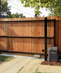 Wooden sliding gate with automated motor installed along V track, showcasing V Groove Cast Iron Wheel 4 By 1.5 Inches handling slide operations.