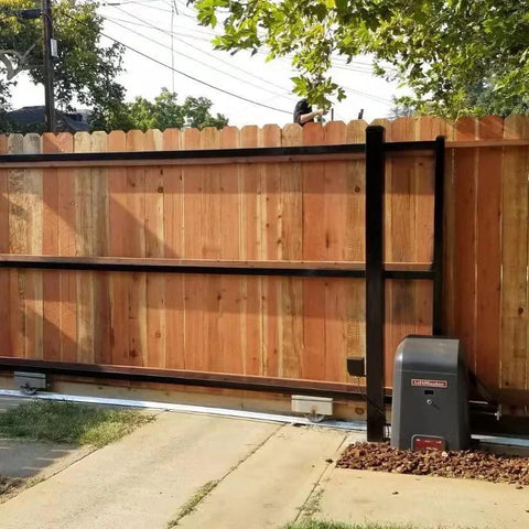Wooden sliding gate with automated motor installed along V track, showcasing V Groove Cast Iron Wheel 4 By 1.5 Inches handling slide operations.