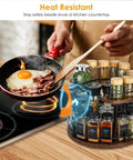 Two Tier Wooden Spinning Lazy Susan Spice Rack next to stove, organizing spices in kitchen with heat-resistant features.