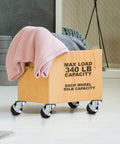 24 Pack 2 Inch Swivel Caster Wheels with Side Brake on a furniture cart holding blankets, showing quiet rolling functionality.