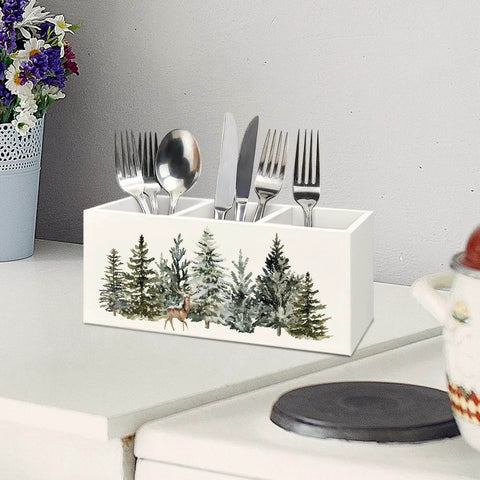 Christmas Tree Wooden Utensils Holder with forest landscape and reindeer, 3-compartments, on white countertop with utensils inside.