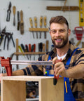 Woodworker using 12 inch woodworking bar clamps set in workshop