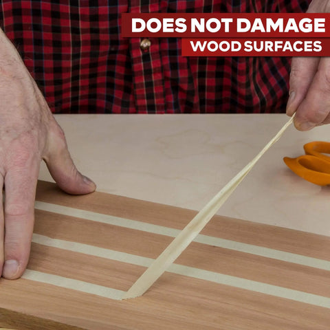 Person removing Double Sided Woodworking Tape 1 Inch Wide, 324 Feet Three Pack, Heavy Duty No Residue Glue Tape from wood surface