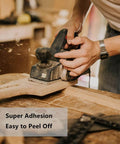 Woodworker using Heavy Duty Double Sided Woodworking Tape For Router Templates And CNC Projects 1 Inch By 82 Feet Removable Double Adhesive Tape With Strong Bond And Easy Peel Ideal For Woodworking Setups.