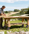 Man assembling wooden structure on outdoor workbench with 5 Inch Outdoor Heavy Duty Caster Wheels Set of 4 with Brakes.