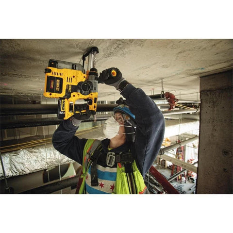Effortlessly drill concrete and perform light chiseling overhead with a compact 20V MAX SDS rotary hammer used by a worker.