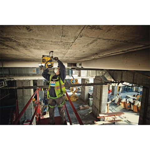 Effortlessly drill concrete and perform light chiseling overhead with a compact 20V MAX SDS rotary hammer used by a worker