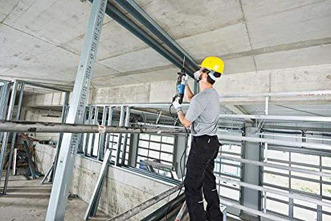 Worker using One And One Eighth Inch SDS-Plus Bulldog Xtreme Max Rotary Hammer for concrete drilling in a construction site.