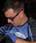Person wearing ANSI Z87.1 Safety Glasses With Anti Fog UV Protection Clear Lens Side Shields working in a dark industrial setting.