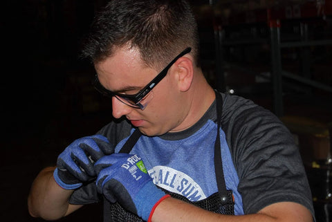 Person wearing ANSI Z87.1 Safety Glasses With Anti Fog UV Protection Clear Lens Side Shields working in a dark industrial setting.