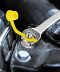 Close-up of 315 Piece SAE And Metric Grease Fittings Assortment Kit with Zerk fitting in use on machinery with yellow cap and wrench.