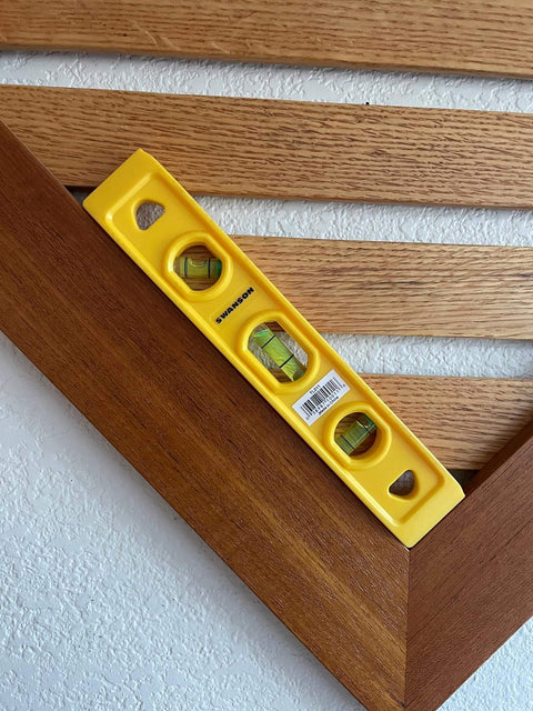 9 Inch Speedlite Torpedo Level Yellow Built With High Impact Composite For Tough Jobsite Use Non Conductive Design Makes It A Handy Third Hand For Electricians And Pro DIYers Swanson Tool TL011 on wood surface