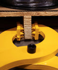Front view of a yellow Beefy Heavy Duty Pallet Puller Clamp With 6000 Lb Capacity gripping a wooden pallet, showing its sturdy steel jaws.