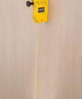 Magnetic plumb bob setter delivers fast, precise vertical alignment with a 14 oz bob, attached to wood with line extended.