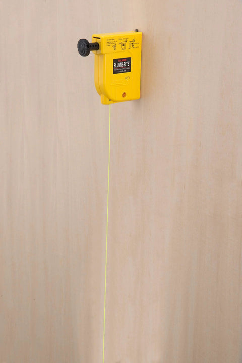 Magnetic plumb bob setter delivers fast, precise vertical alignment with a 14 oz bob, attached to wood with line extended.