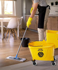 Yellow mop bucket in a kitchen with Four Piece Mop Bucket Wheel Replacement Set Non Marking TPR Casters For Models 7570 L2.