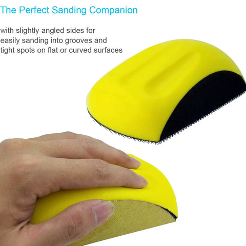 Hand holding yellow mouse-shaped 5-inch sanding block for hook-and-loop discs, ideal for precise sanding in grooves.