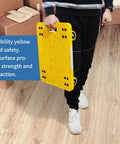 Person holding High Visibility Yellow 300-lb Capacity Movers Dolly with 4 Swivel Casters, 19-1/2" x 14-1/2" Platform