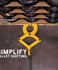 Top view of yellow Beefy Heavy Duty Pallet Puller Clamp With 6000 Lb Capacity attached to a pallet, showing usage on wooden pallet.
