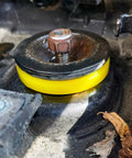Yellow 2 Pack Silencer Shock Bushings For Shock Absorption And Noise Reduction installed on car suspension.