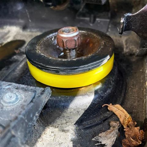 Yellow 2 Pack Silencer Shock Bushings For Shock Absorption And Noise Reduction installed on car suspension.