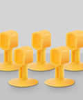 Front view of five soft yellow silicone doorknob cushions displayed on a gray surface.