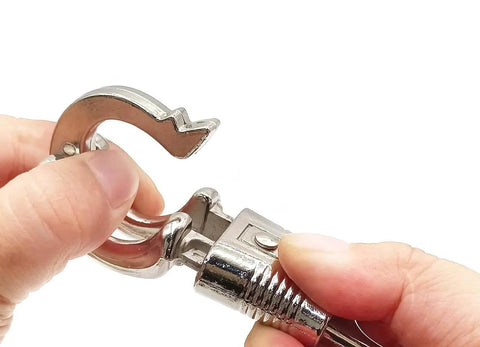 Close-up of a zinc alloy quick release panic snap being held, part of 10 Pack Panic Snap Quick Release Metal Snap For Paracord And Get Back Whips.