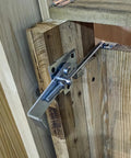 Zinc Barn Door Jamb Latch With Hook 7 Inch Cam Latch installed on a wooden sliding door, showing adjustable latch mechanism.