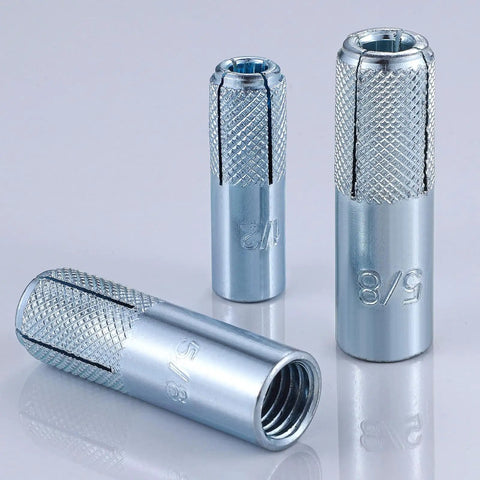Pro Grade Zinc Plated Concrete Drop In Anchors 20 Pack Knurled For Solid Concrete With Internal Forced Expansion Screws Quarter Inch By Twenty Thread Assortment, showing three knurled anchors in different orientations on a reflective surface.