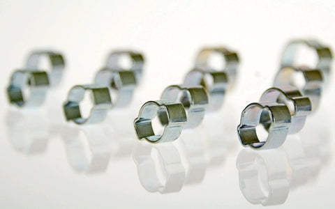 Close-up of zinc-plated steel clamps from Swordfish Two Ear Hose Clamp Assortment 125 Piece Kit By Swordfish Tools, showing smooth deburred edges.